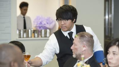 Waiter serving custormers.