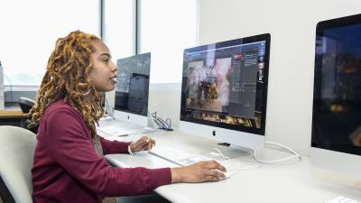 Student works at a computer in a computer lab.