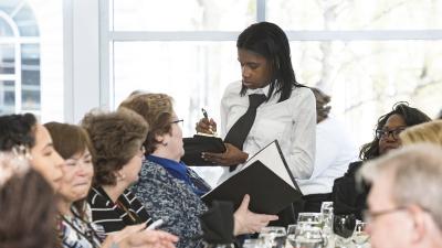 A waiter takes an order from a customer