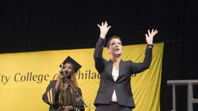 An ASL translator accompanying a student singer at the College's commencement ceremony