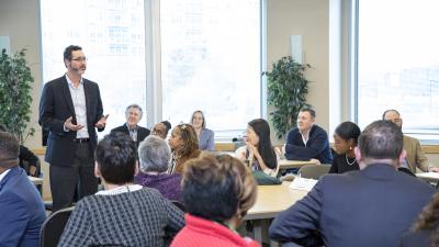 Businessman speaks to a room full of business owners.