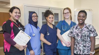 A group of health services students smiling.