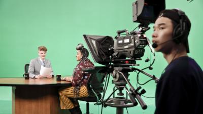 Students on set a t a news desk 