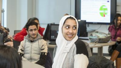 Two students engaged in a class lecture.