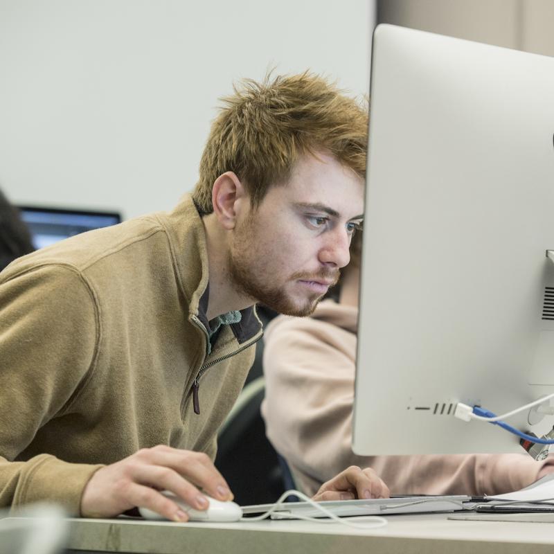 Man works at a computer.