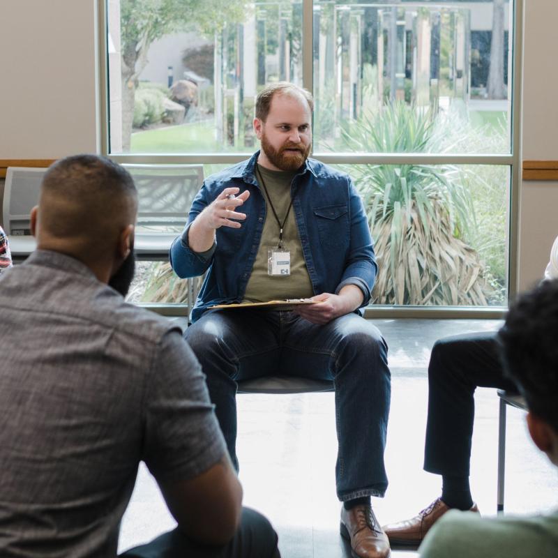 A therapist shares insights during a group session