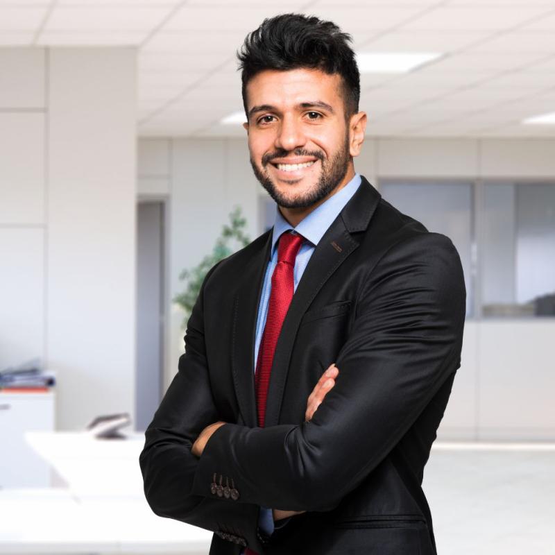 Man in business suit smiles for the camera.
