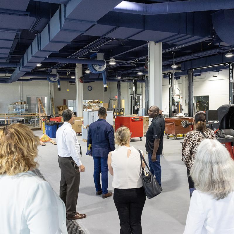 Warehouse manager gives a group tour.