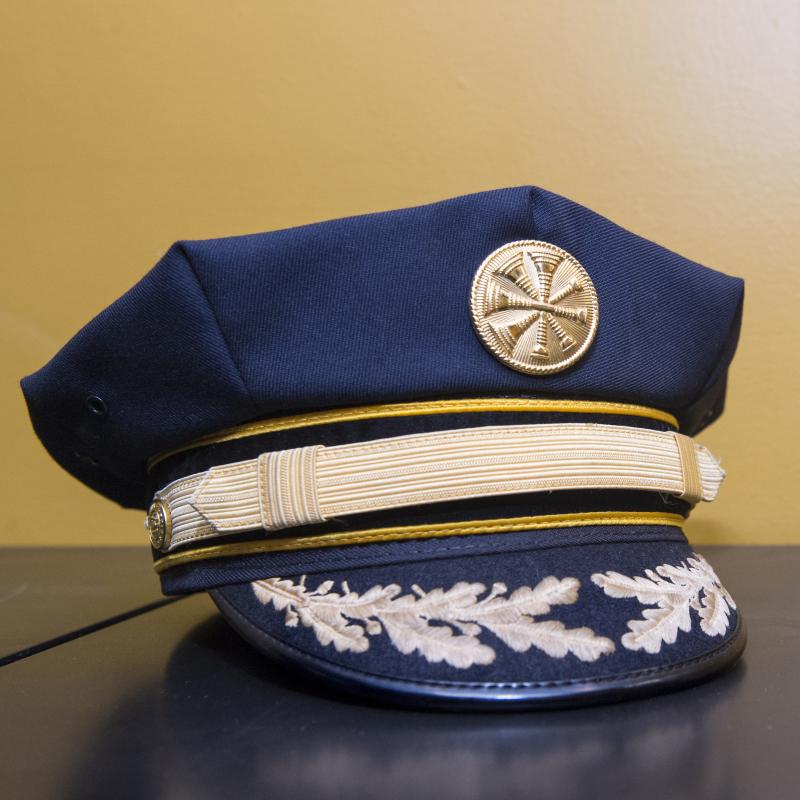 Firefighter's cap sitting on a table.