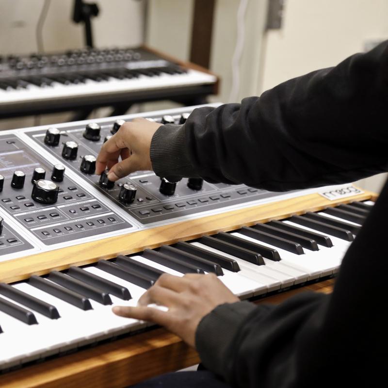 Hands working at electronic keyboard.