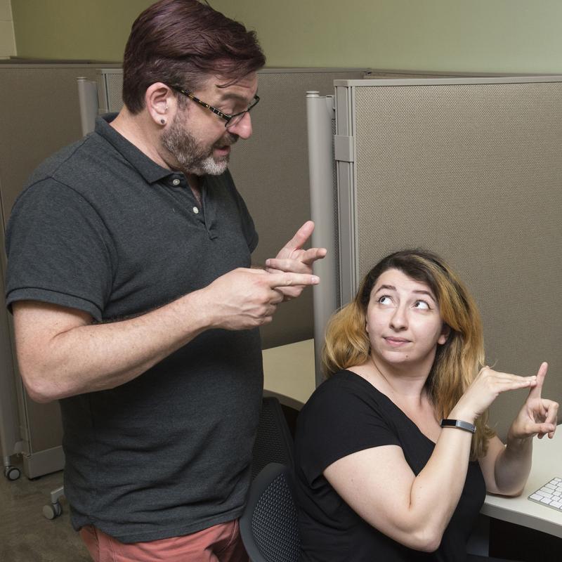 Professor instructing a student using ASL
