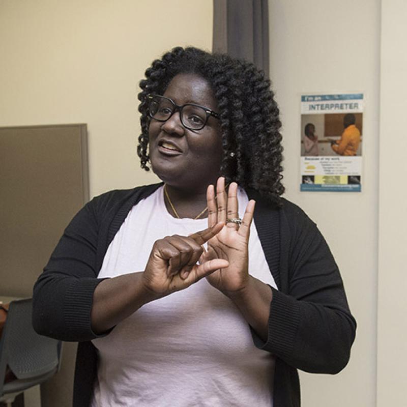American Sign Language translator in conversation at the College