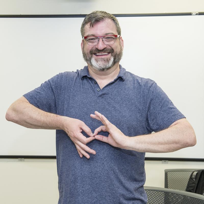 Smiling ASL professor in the classroom