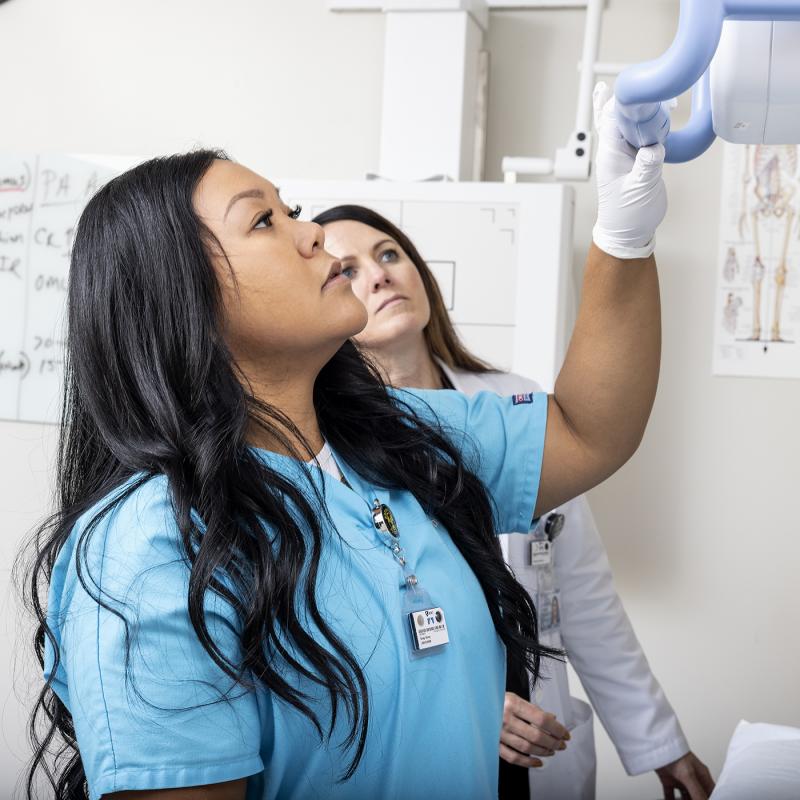Student looking up at a medical machine