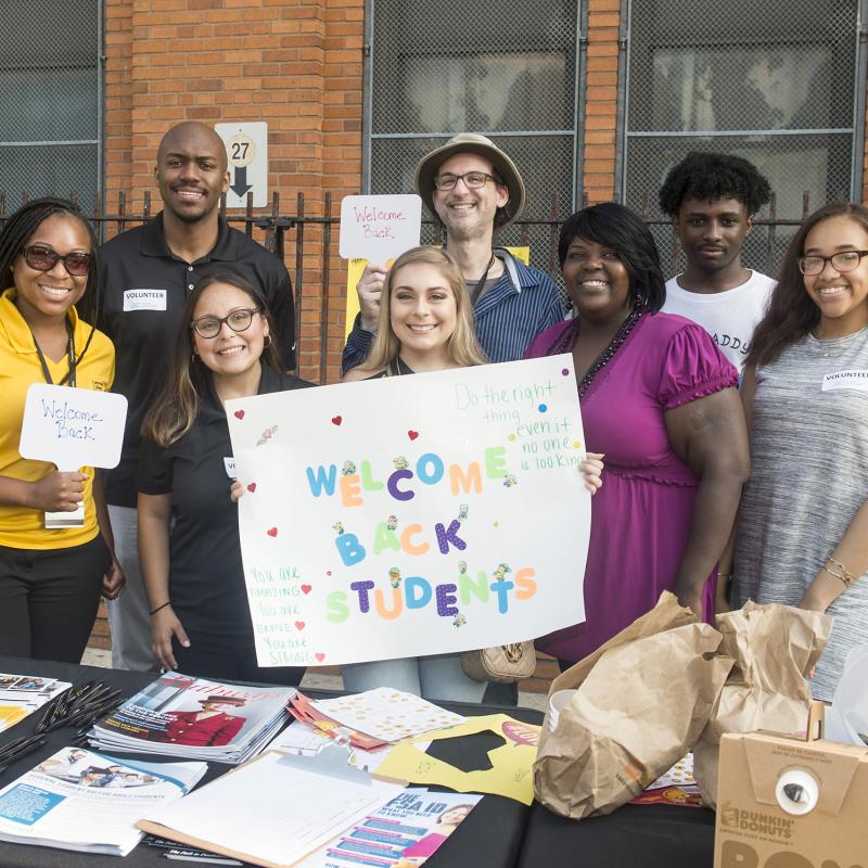 Group of Volunteers smiles for the camera.