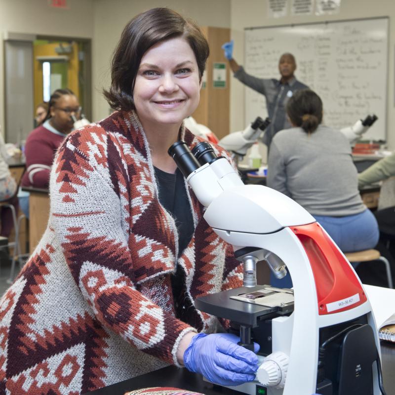Student working with a microscope
