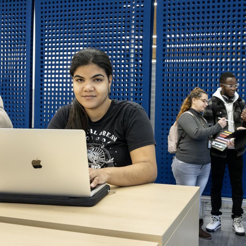Student on a Laptop smiling at the camera