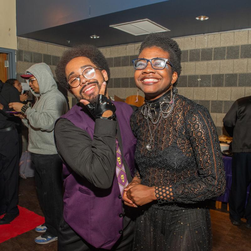Students smiling at the camera at Queer Prom