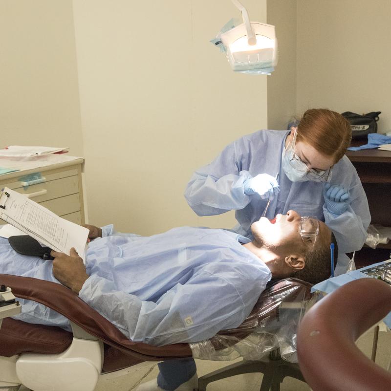 Student practicing Dental Hygiene techniques on another student