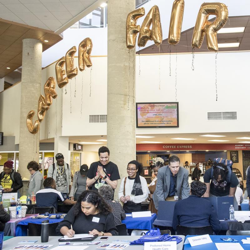 Students talking with employers during an on campus career fair