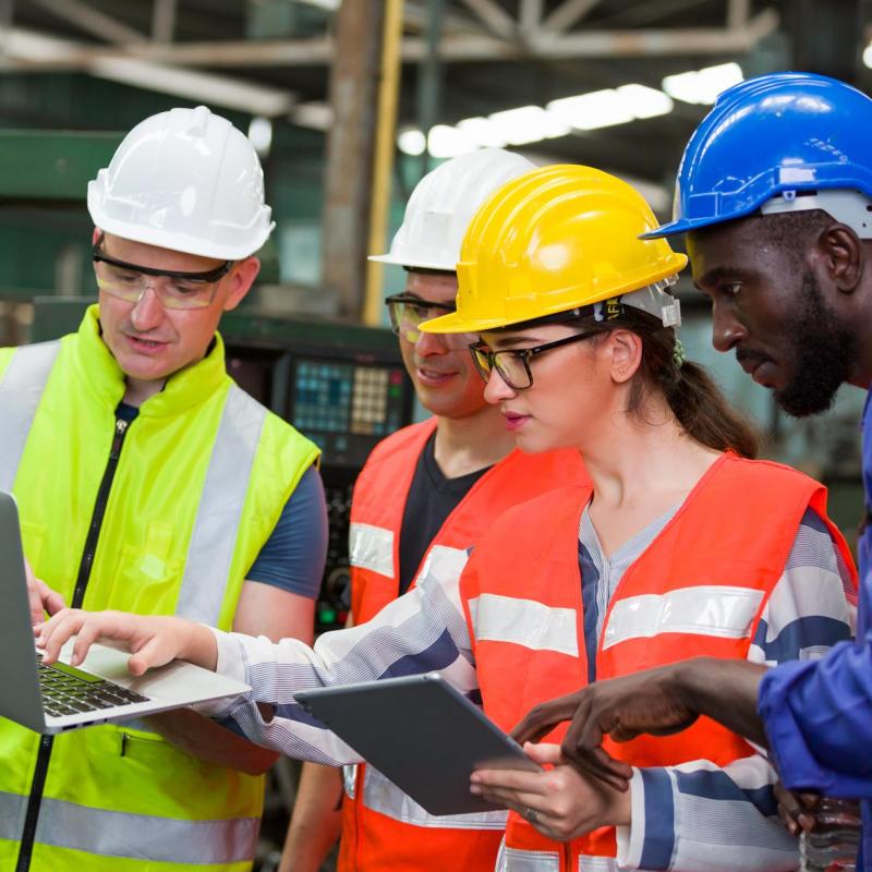 workers in hard hats reviewing plans
