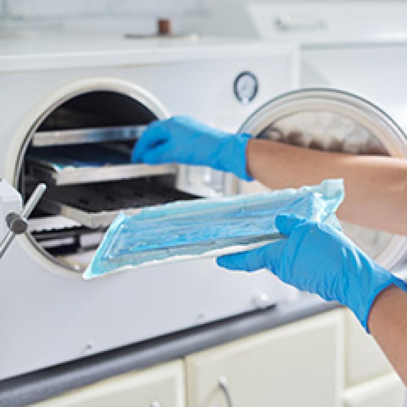 Medical worker sterilizing instruments