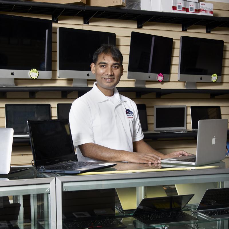 Person surrounded by fixed computers for sale