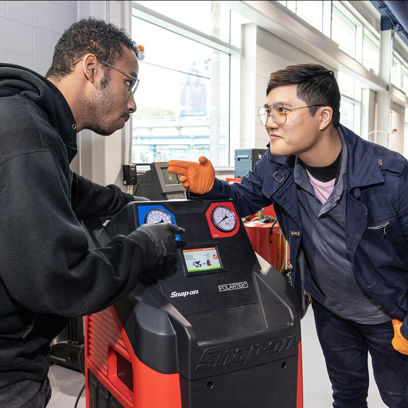 students using a snap on tools machine