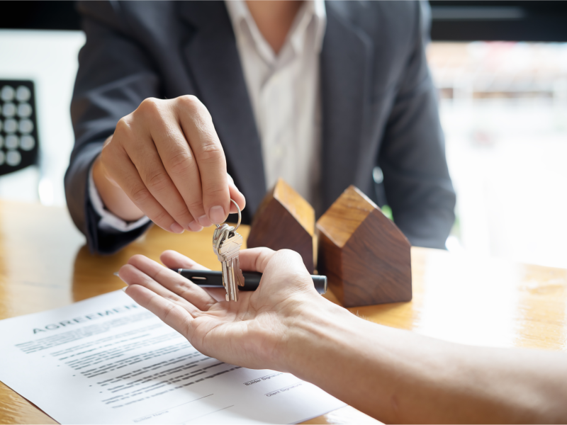 Real estate agent handing a key over to a buyer
