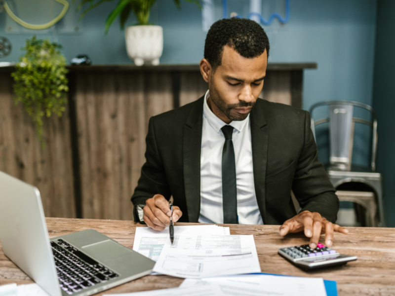 A busy accountant works at his desk