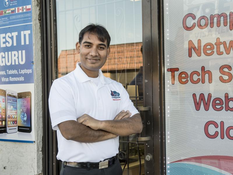 Person smiling outside computer store