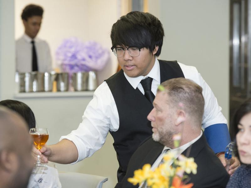 Waiter serving custormers.