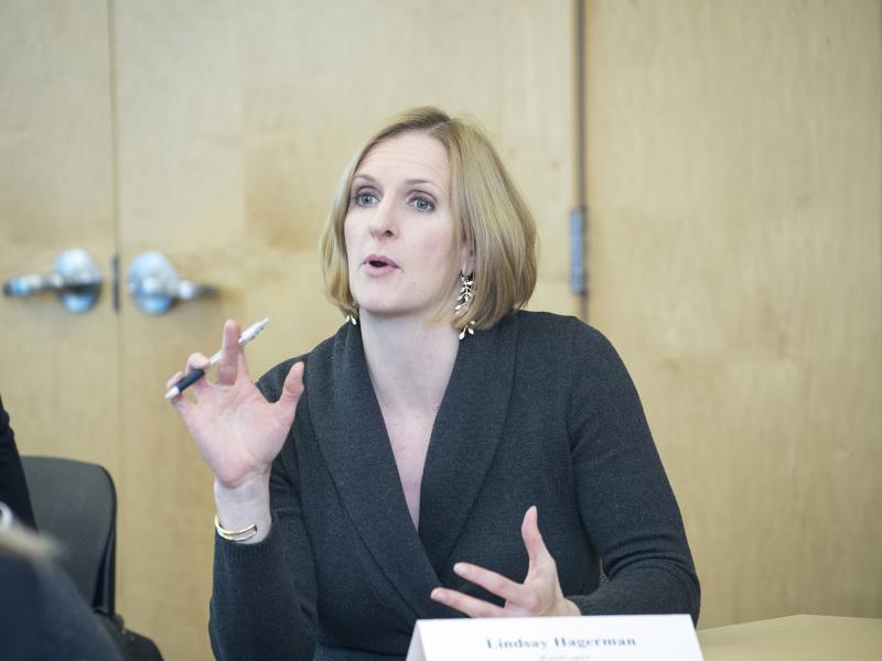 Business woman with pen in her hand speaks.