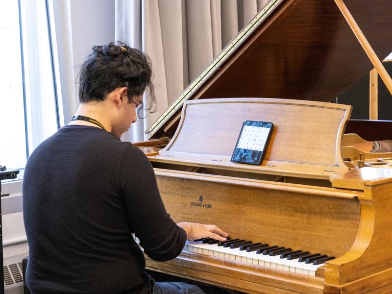 Student Plays and baby grand piano.