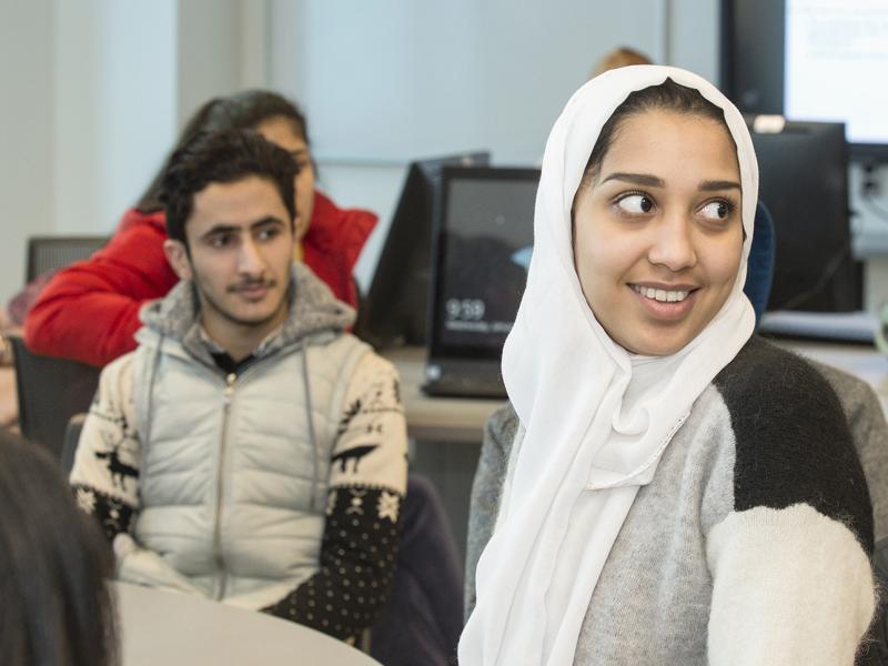 Two students engaged in a class lecture.