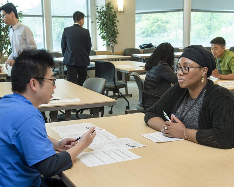 A student meets with a recruiter from a large Philadelphia business at a Career Fair