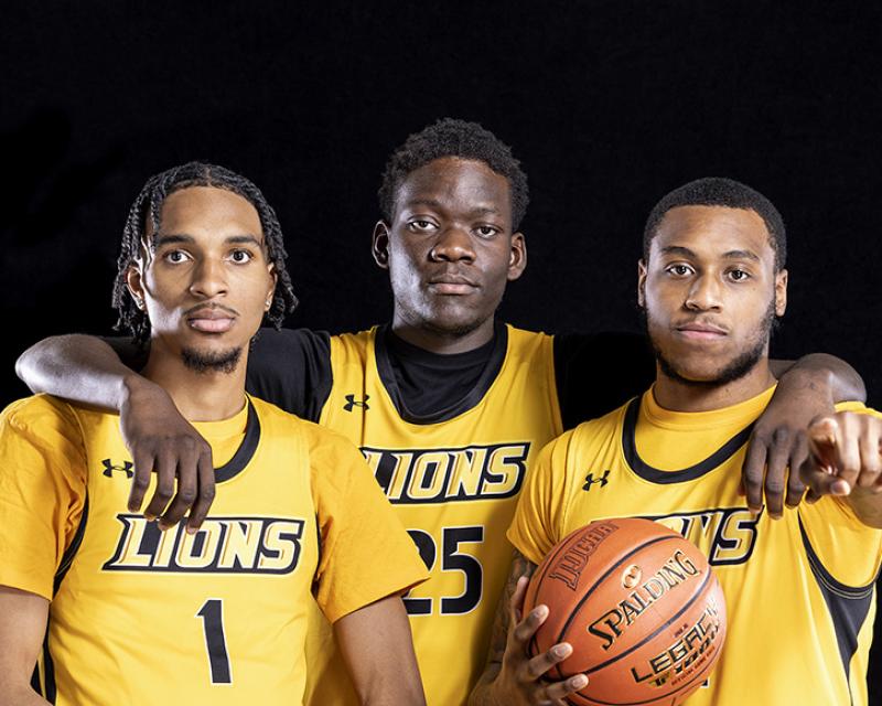 Three members of the College's Men's Basketball Team in a studio photo shot