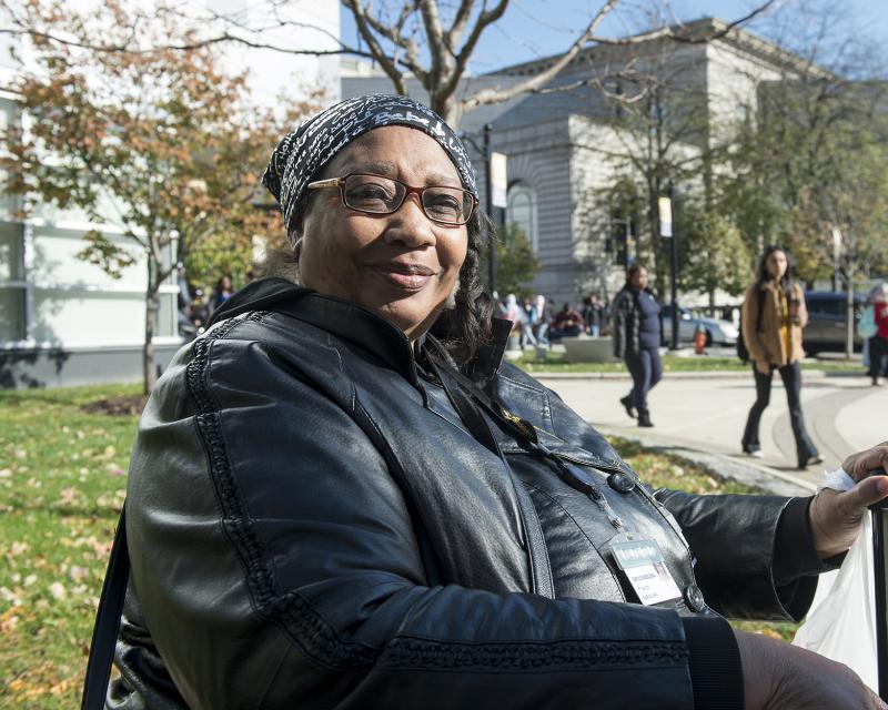 Woman sitting on Campus smiling 
