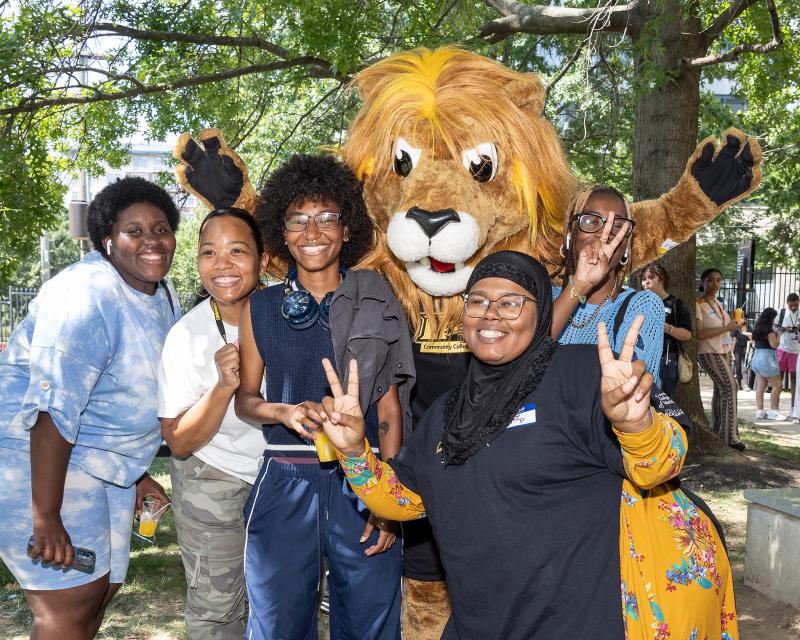 Students Standing with Roary the Lion 