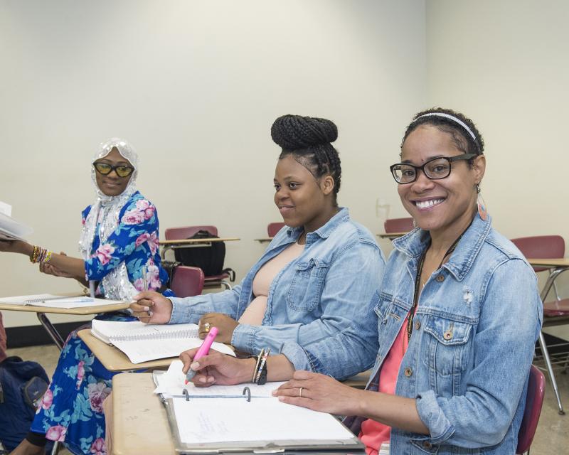 students in an english classroom together smiling 