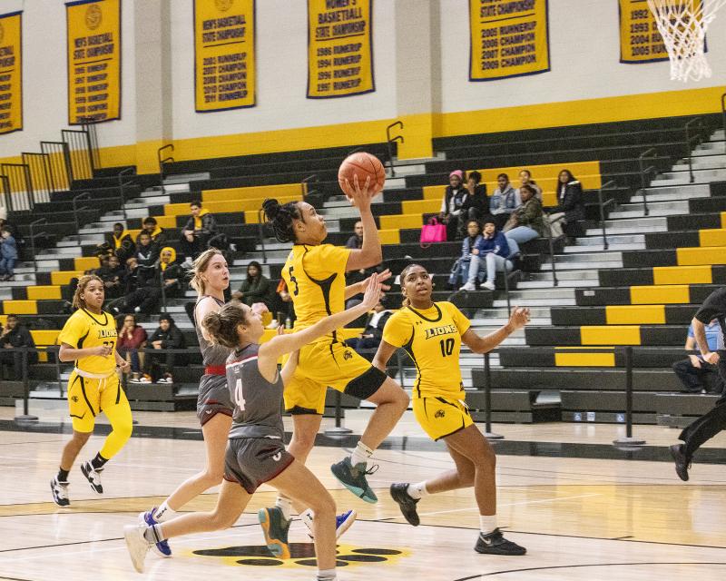 Women's Basketball player going for a layup