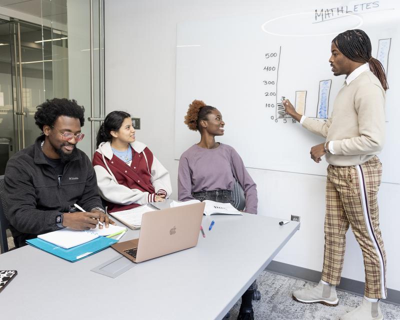 Students learning from a tutor