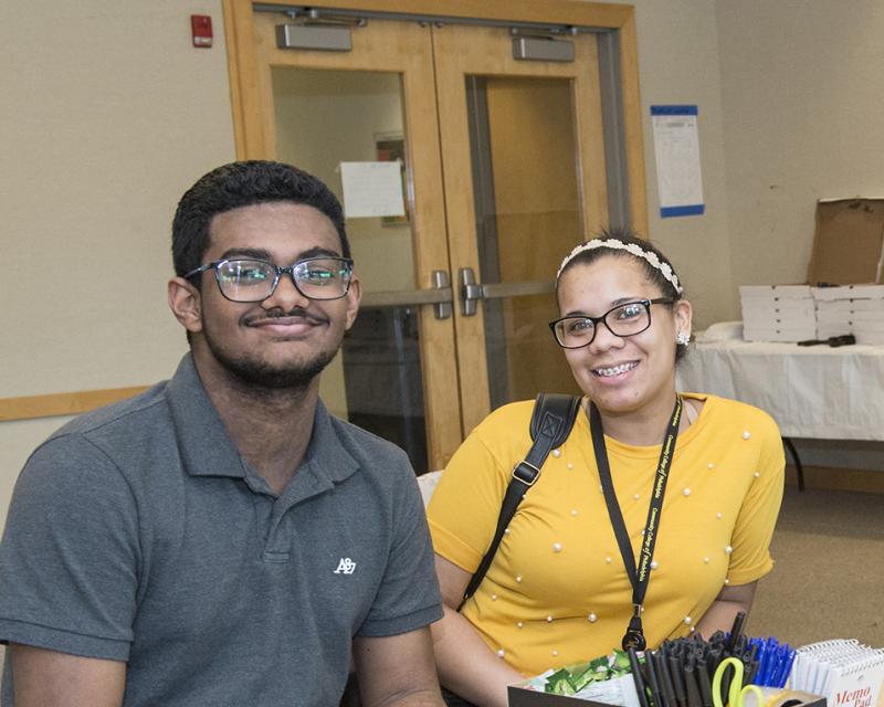 students and teacher smiling at camera