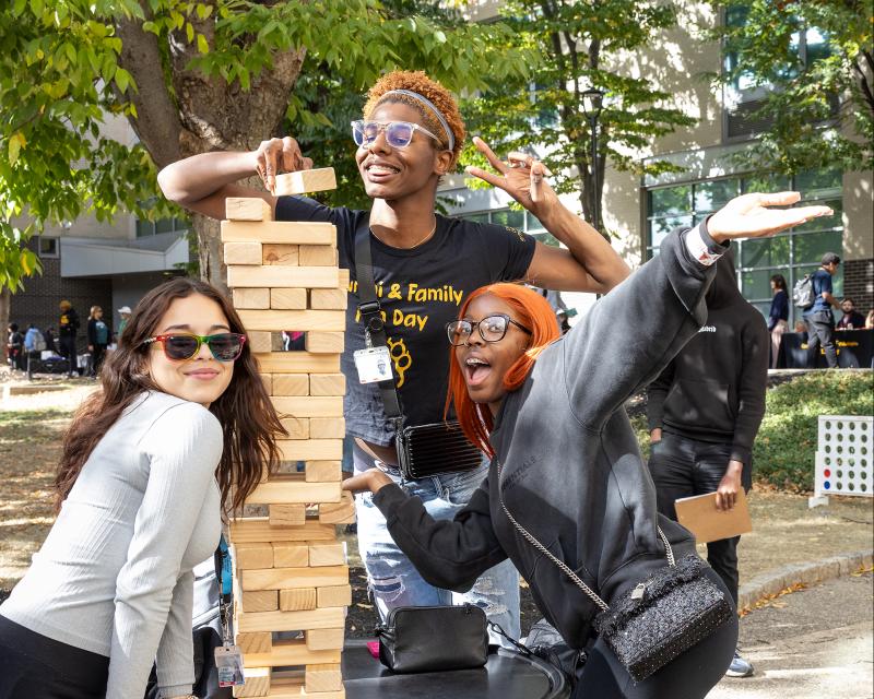 Students playing a game of giant JENGA at outdoor family fun day
