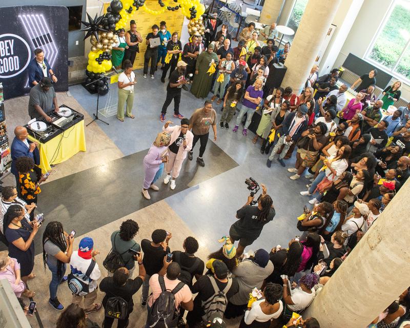 Students surrounding speakers at College event in the Bonnell Lobby