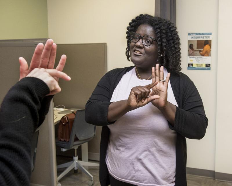 female student practicing ASL