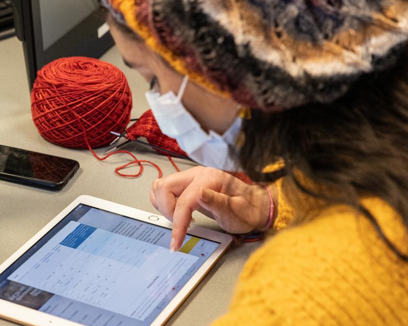 A student works on an assignment on a digital tablet.