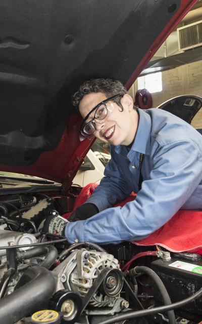 Coco H working on a car